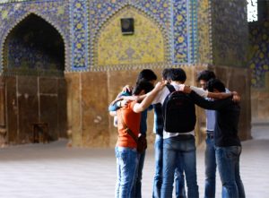 young-men-praying-outside-mosque-medium