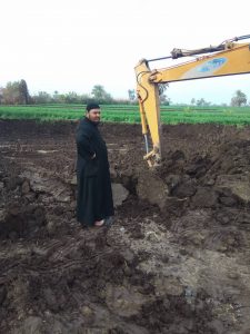 Fr Feltaws Ibrahim overseeing digging