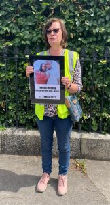 Pamela holding placard