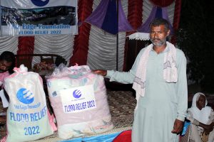 Pakistan Man with flood Relief bags