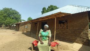 Women in front of re-roofed house