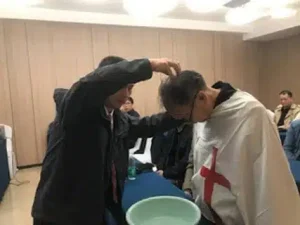 Elder Li baptising at Good Land Mission Centre